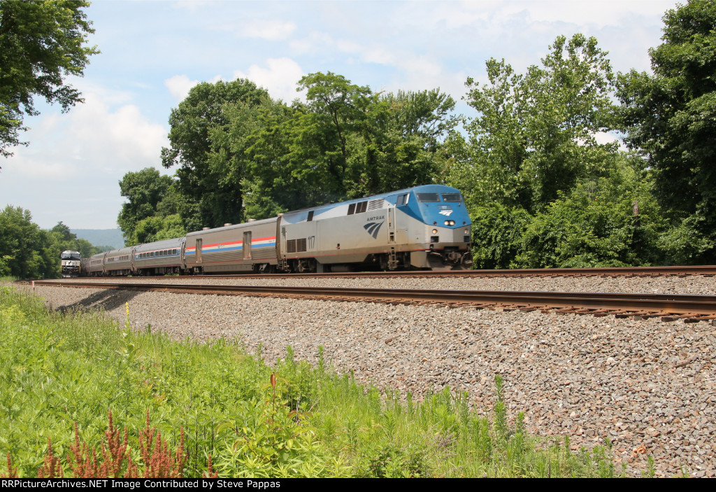 AMTK 117 takes train 04T toward Harrsiburg, while a stack train waits on the siding